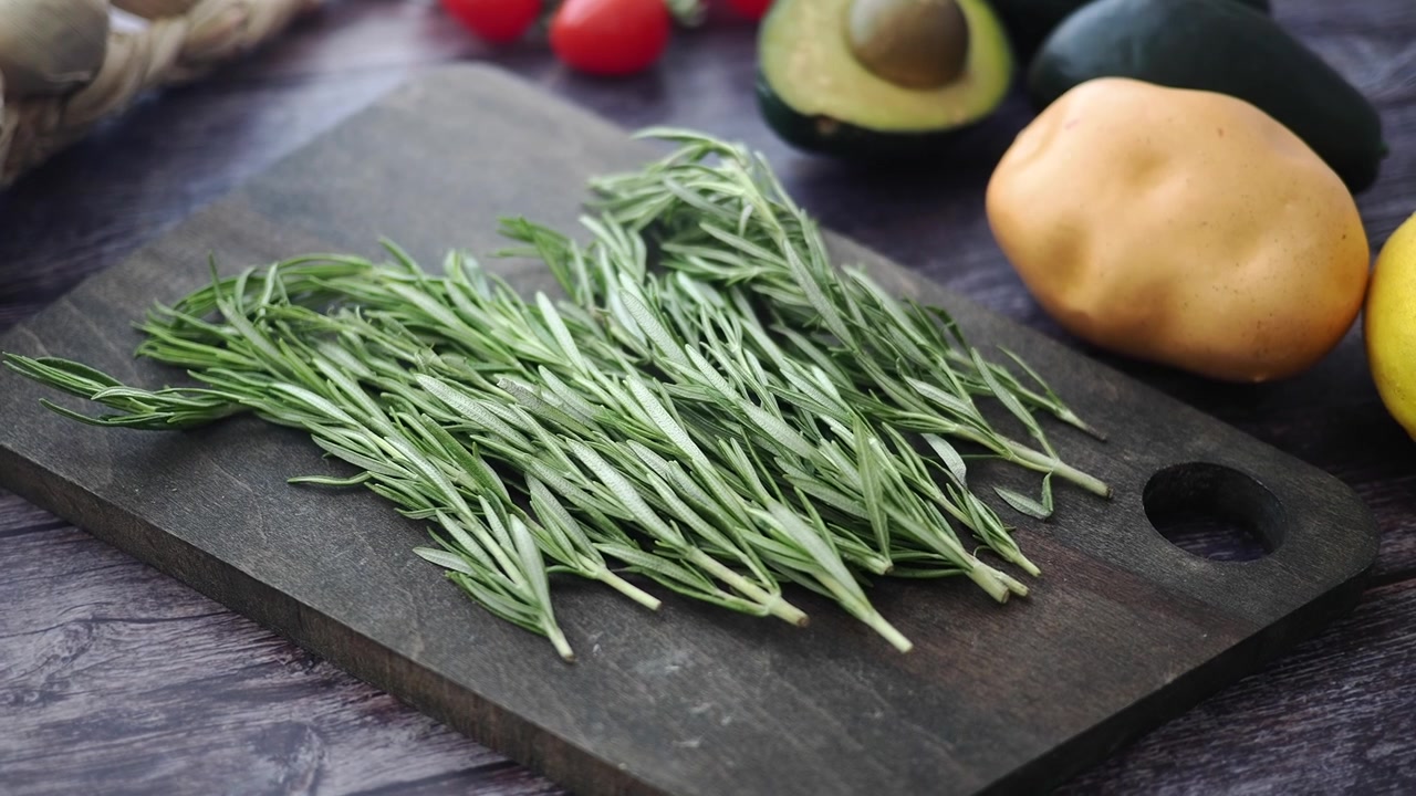 Fresh Rosemary Sprigs on a Wooden Cutting Board