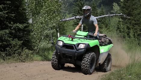 shot of a rider driving his atv off of a jump and catching a little air