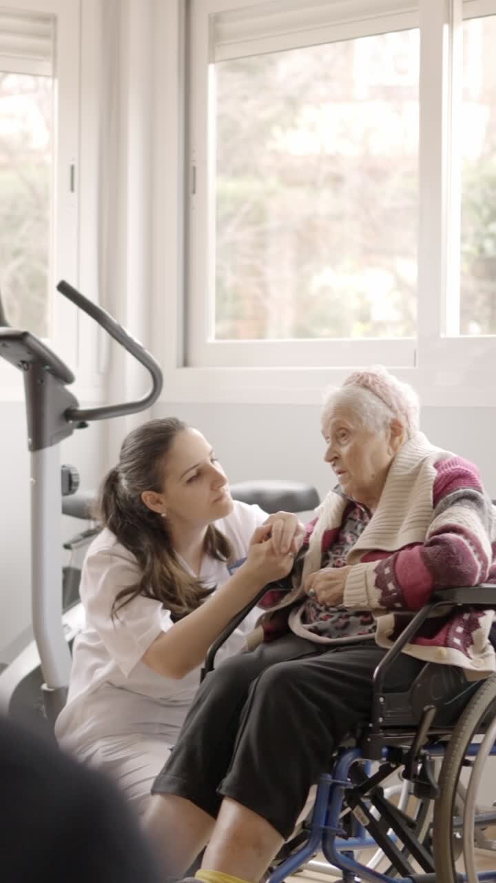Female doctor listening carefully to a old woman