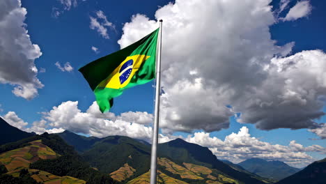 brazilian flag waving over mountainous landscape
