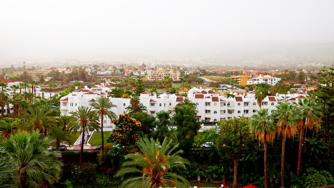 Panoramic view over urban town in Tenerife, Canary Islands, Spain.
View of the buildings, palm trees and green lush vegetation.