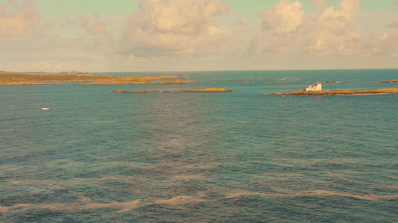 Serene lighthouse view on North Sea island, clear blue waters, peaceful mood