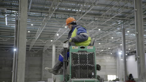 trabajador de la construcción que opera equipos en un almacén