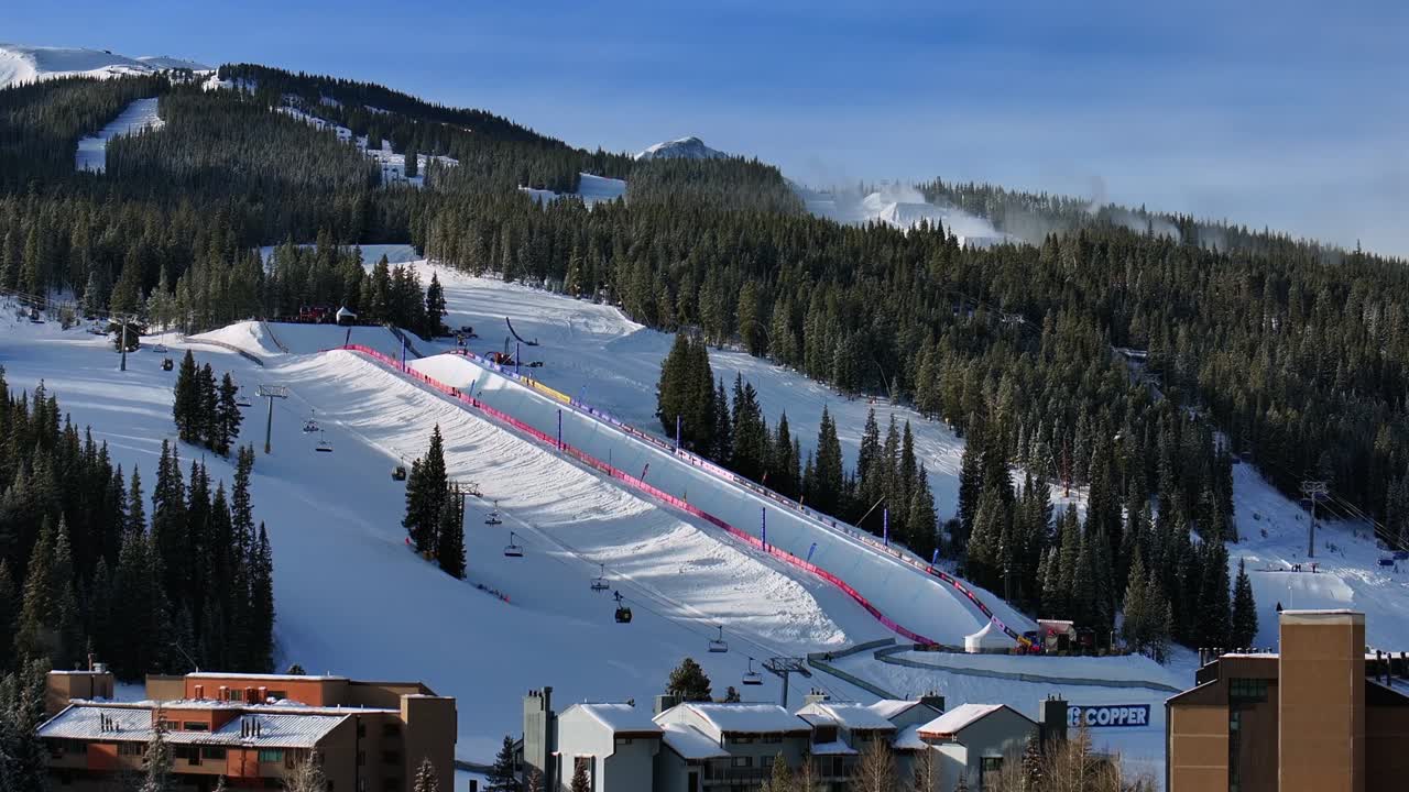 Copper Mountain Resort center village aerial drone chairlifts gondola Ikon Pass Alterra snowboarding snow ski riding trails morning winter solstice December halfpipe snow guns trees upward jib motion