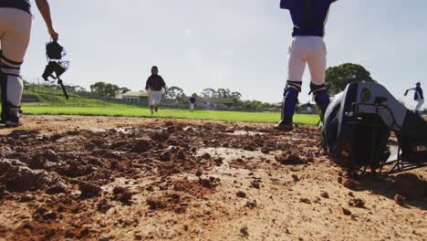 diverse group of female baseball players, fielder attempting to catch running hitter at base