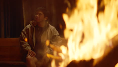 person sitting by a campfire