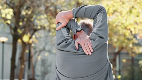 senior man stretching his arms outdoors