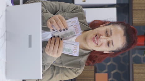 Vertical-video-of-Business-woman-counting-money-looking-at-camera.