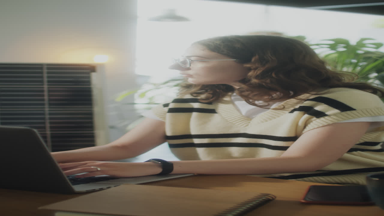 Girl Using Laptop in Office with Renewable Energy