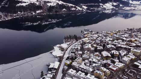 breathtaking winter wonderland town in austria zell am see facing lake, aerial