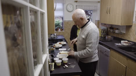elderly couple preparing food in kitchen