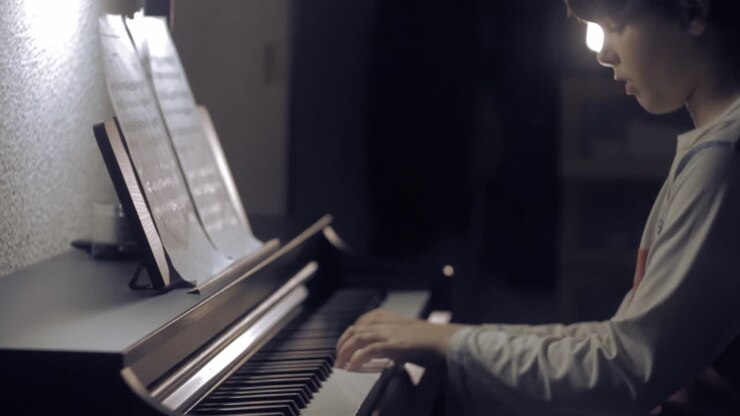Young boy playing piano, medium shot