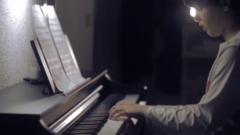 young boy  playing piano, medium shot