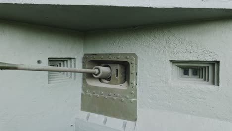 old historical concrete bunker facade with a cannon from world war ii