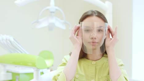 happy dentist dressing up protective mask in dental clinic