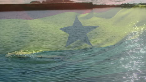 swimming in ocean, person with translucent flag animation overlay in background