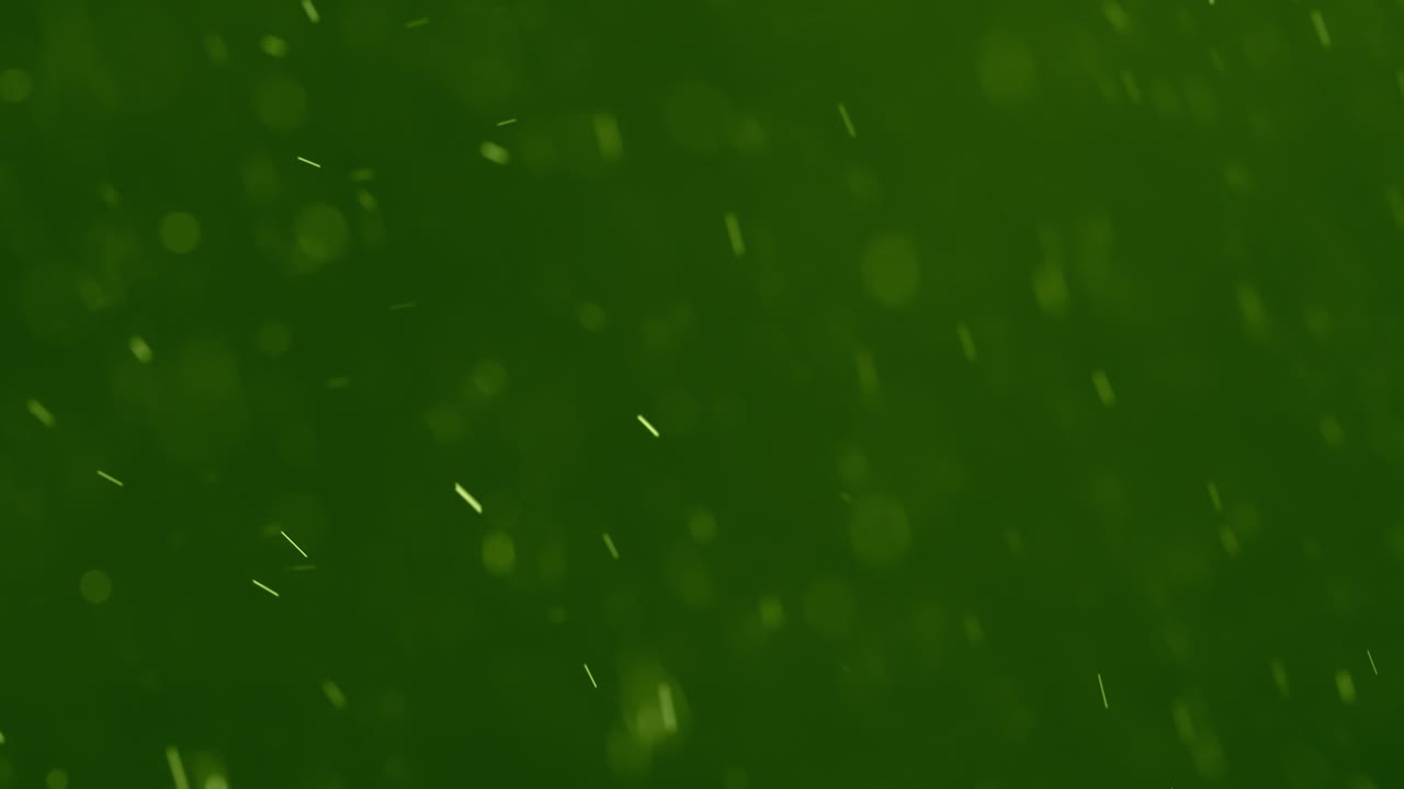 White Swirling Particles against a Green Background