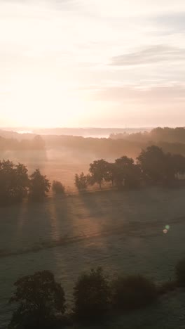 sunrise over a misty countryside landscape