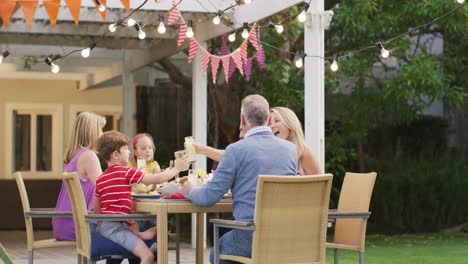 three generation family enjoying lunch outdoors