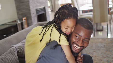 Happy-african-american-daughter-and-father-fooling-around-at-home