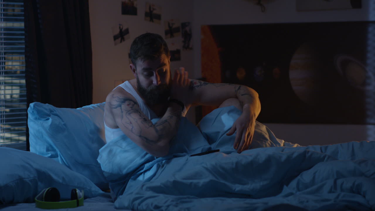 Man Stressed in Bed at Night