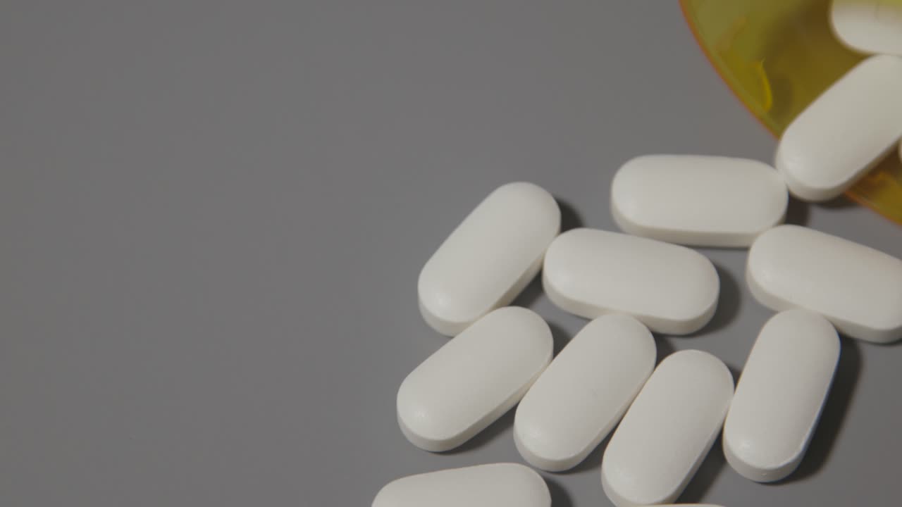 White Pills Spilled from a Bottle