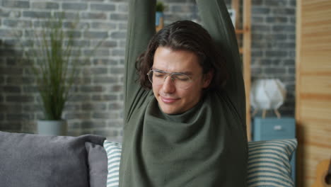 man stretching on couch