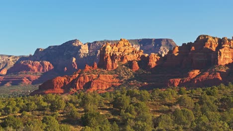 drone orbit or parallax around desert alpenglow illuminating submarine rock, sedona arizona