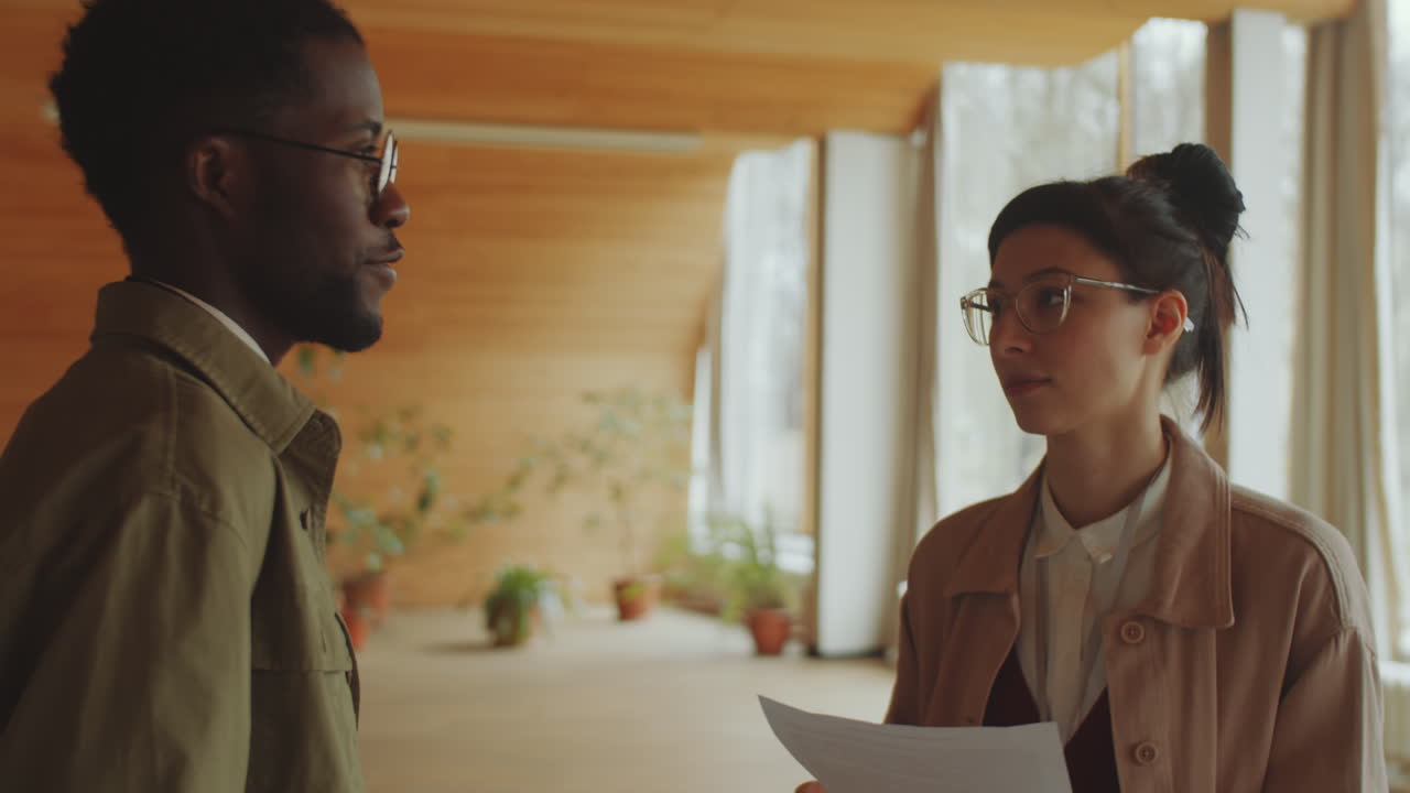 Cheerful Library Workers Talking in Auditorium