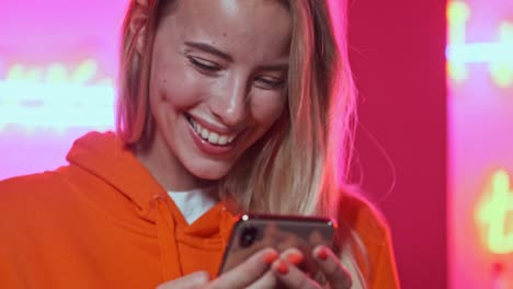 close up view of happy woman using smartphone and enjoying