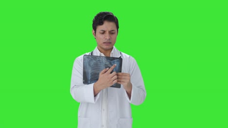 Confused-Indian-doctor-explaining-X-ray-report-to-patient-Green-screen