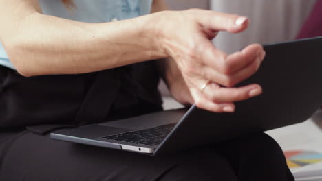 woman hands typing on laptop at home office. girl freelancer closing laptop.