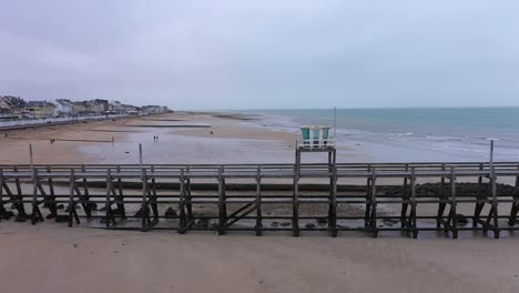 Drone-shot-of-the-luc-sur-mer-pier-in-normandy