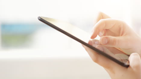 woman hand touching tablet computer surface touchscreen pad