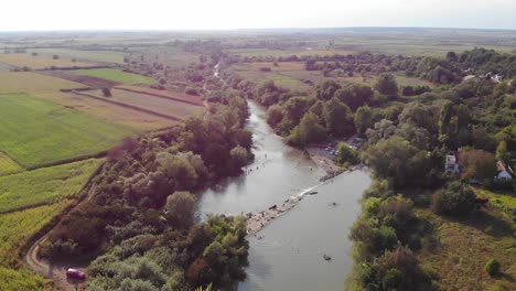 drone aerial romania countryside river trees swamp green fields