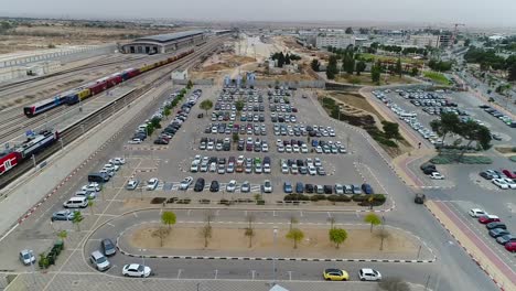 take drone aerial over a parking area and basketball courts.