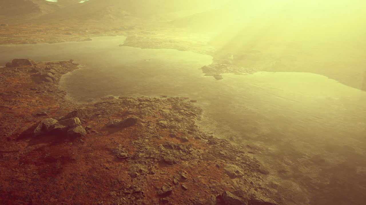 Mysterious twilight landscape with shimmering water and rugged terrain