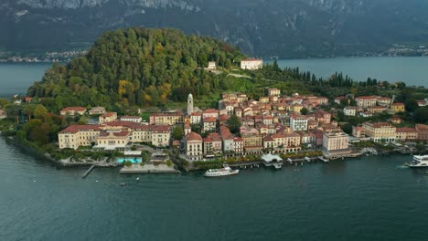 aerial: villas of bellagio during last sun of the day on lake como