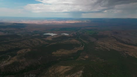 raining lands end hill climb grand mesa grand junction colorado aerial drone summer morning clouds thunderstorm rain sunny western slopes delta montrose olathe shade dark pan left motion