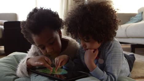 two children playing with digital tablet at home shot on r3d