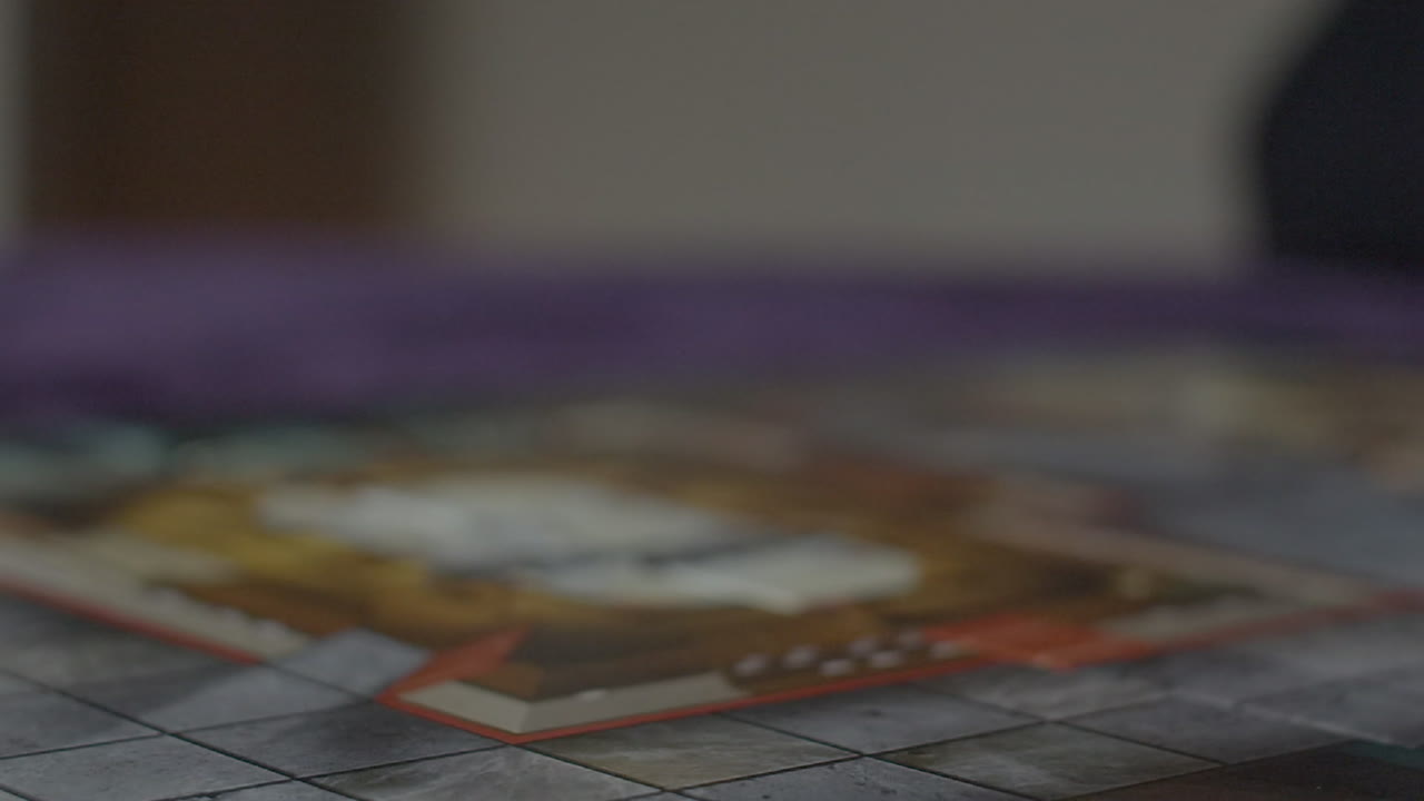 Dice rolling in slow motion into frame - number 3 visible