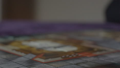 dice rolling in slow motion into frame - number 3 visible