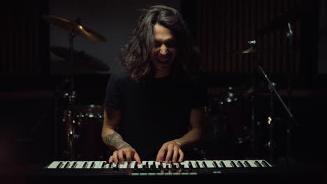 expressive man playing rock indoor. cheerful guy having fun in music studio.