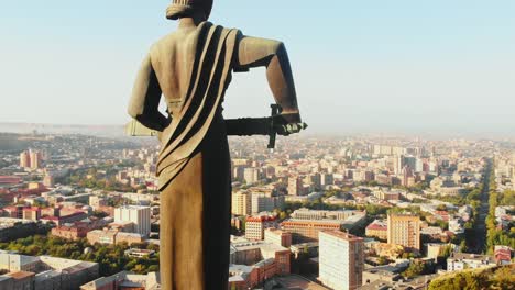 yerevan, armenia - 2nd september, 2021: the statue of mother armenia. mother armenia monument aerial close rising view. in background street, buildings victory park in yerevan