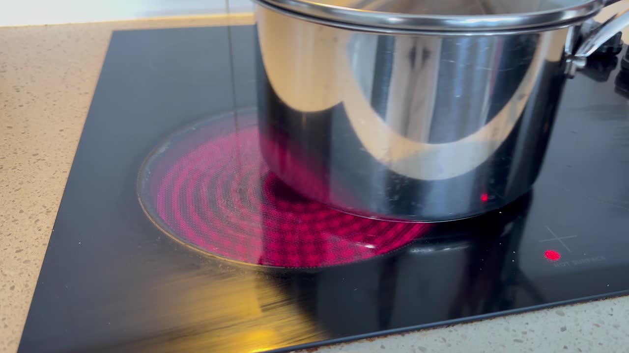 Pot heating on electric stove in kitchen