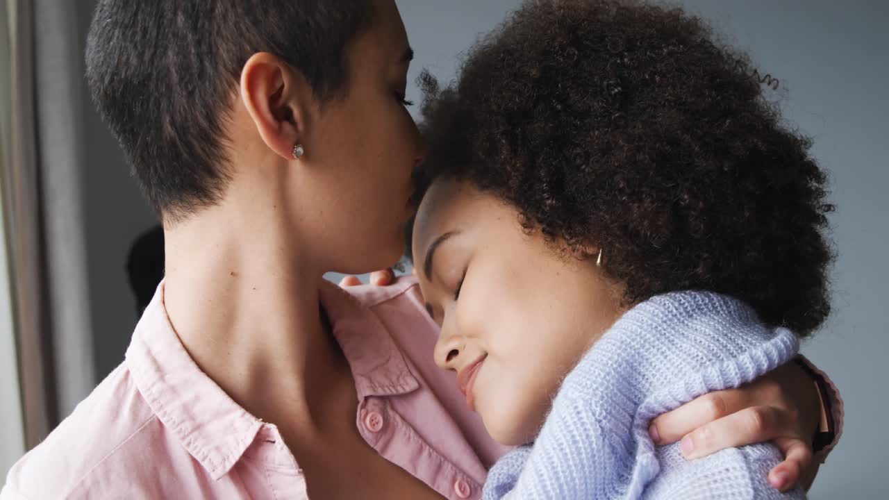 Lesbian couple romancing at window
