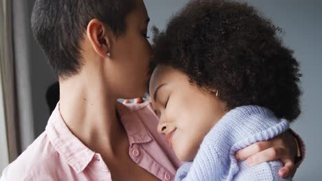 Lesbian-couple-romancing-at-window