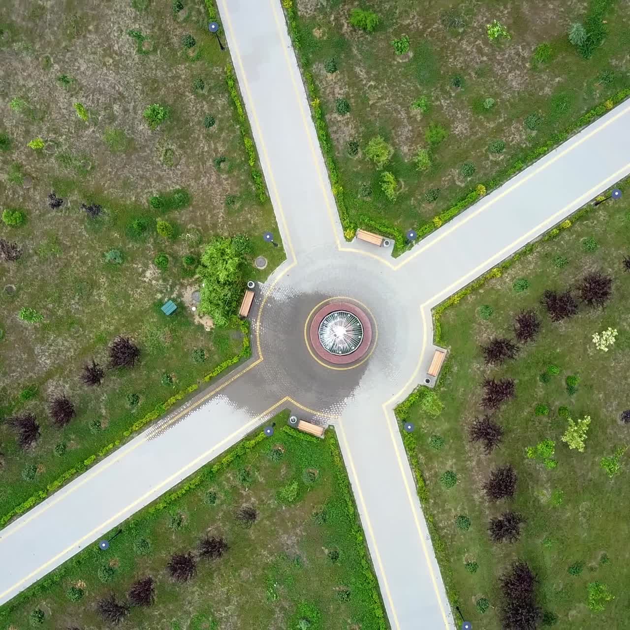 Paths in the park with fountain in the middle and four benches. Top view on the landscape design of a green city area