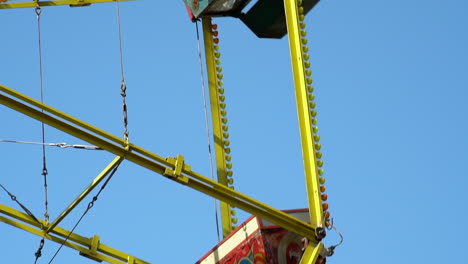 slow motion of the ferris wheel amusement ride buckets spinning at the fun fair