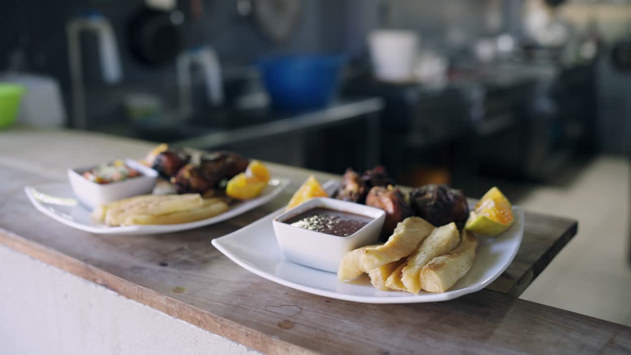 Appetizing Plates of Meat, Yuca, and Sauce in a Restaurant Kitchen